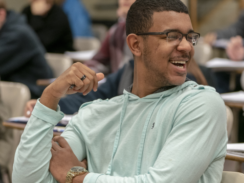 Student laughing in classroom.